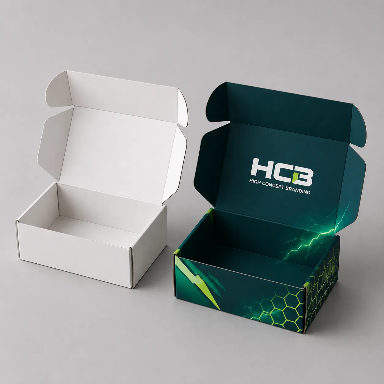 Custom printed cardboard mailer boxes for vape battery packaging alongside an unprinted white prototype box. class=